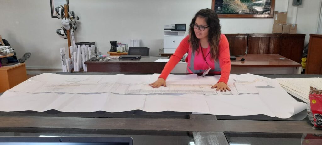 Engineer reviewing hard copies of maps to be digitized